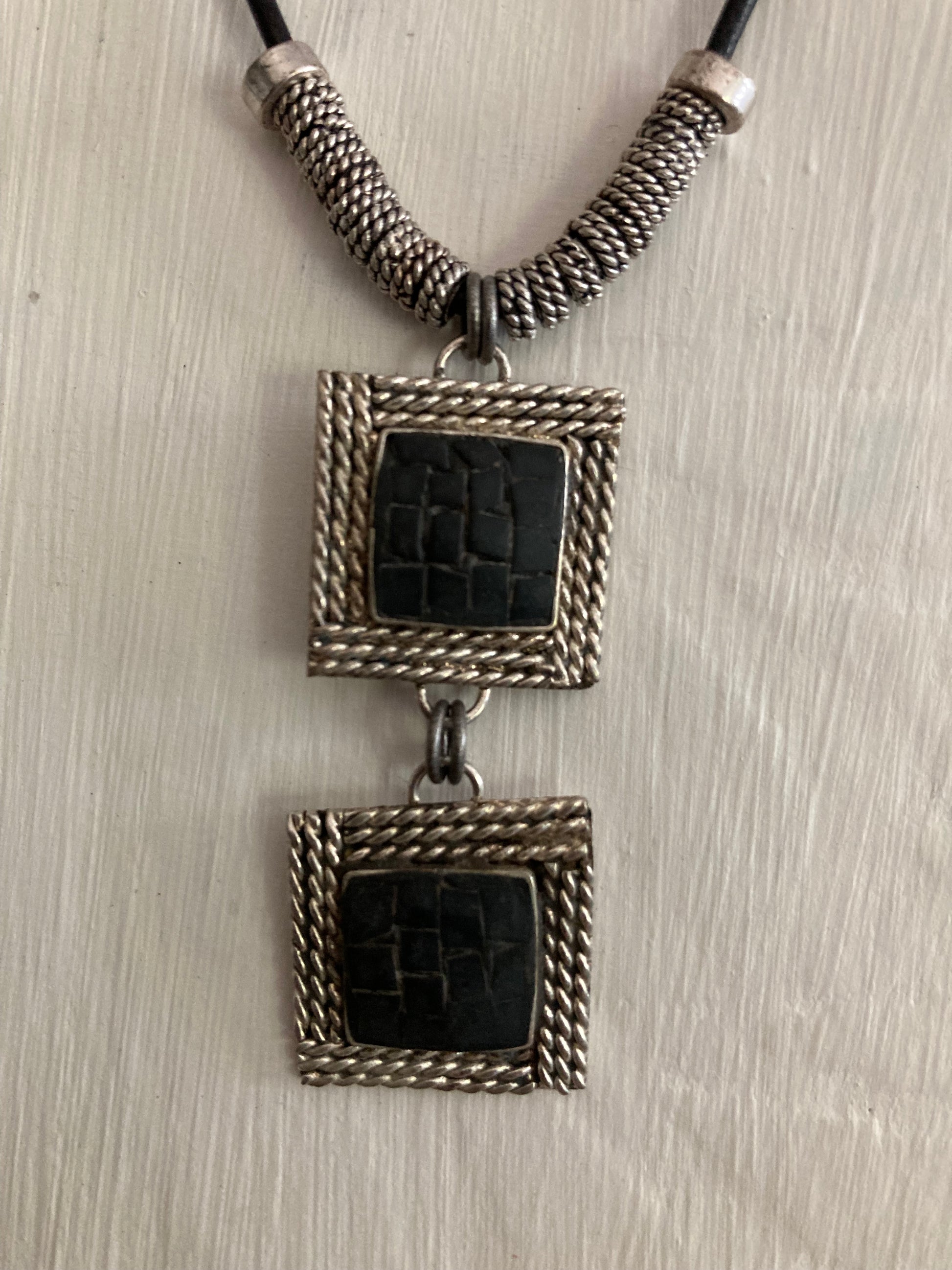 Black mosaic pendants on leather cord with antique silver spacers and beads