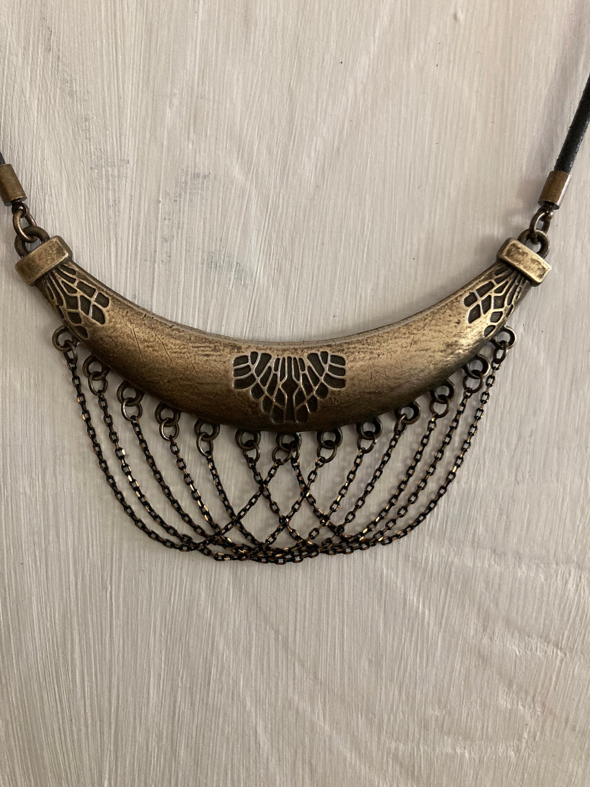 unique leather necklace with large brass pendant with tribal pattern