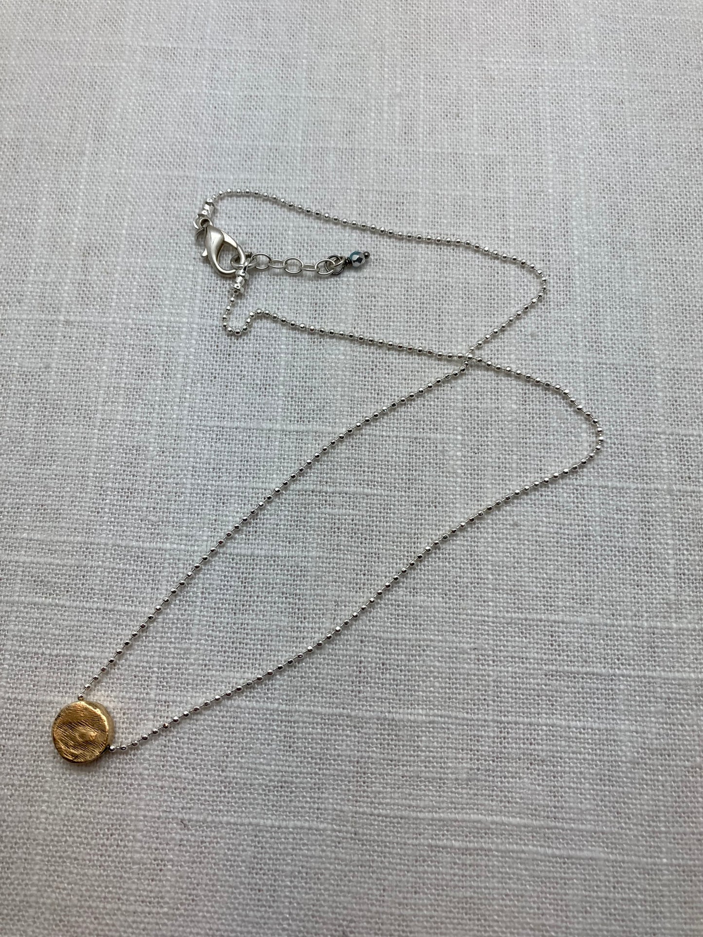 distressed gold bead necklace on silver chain