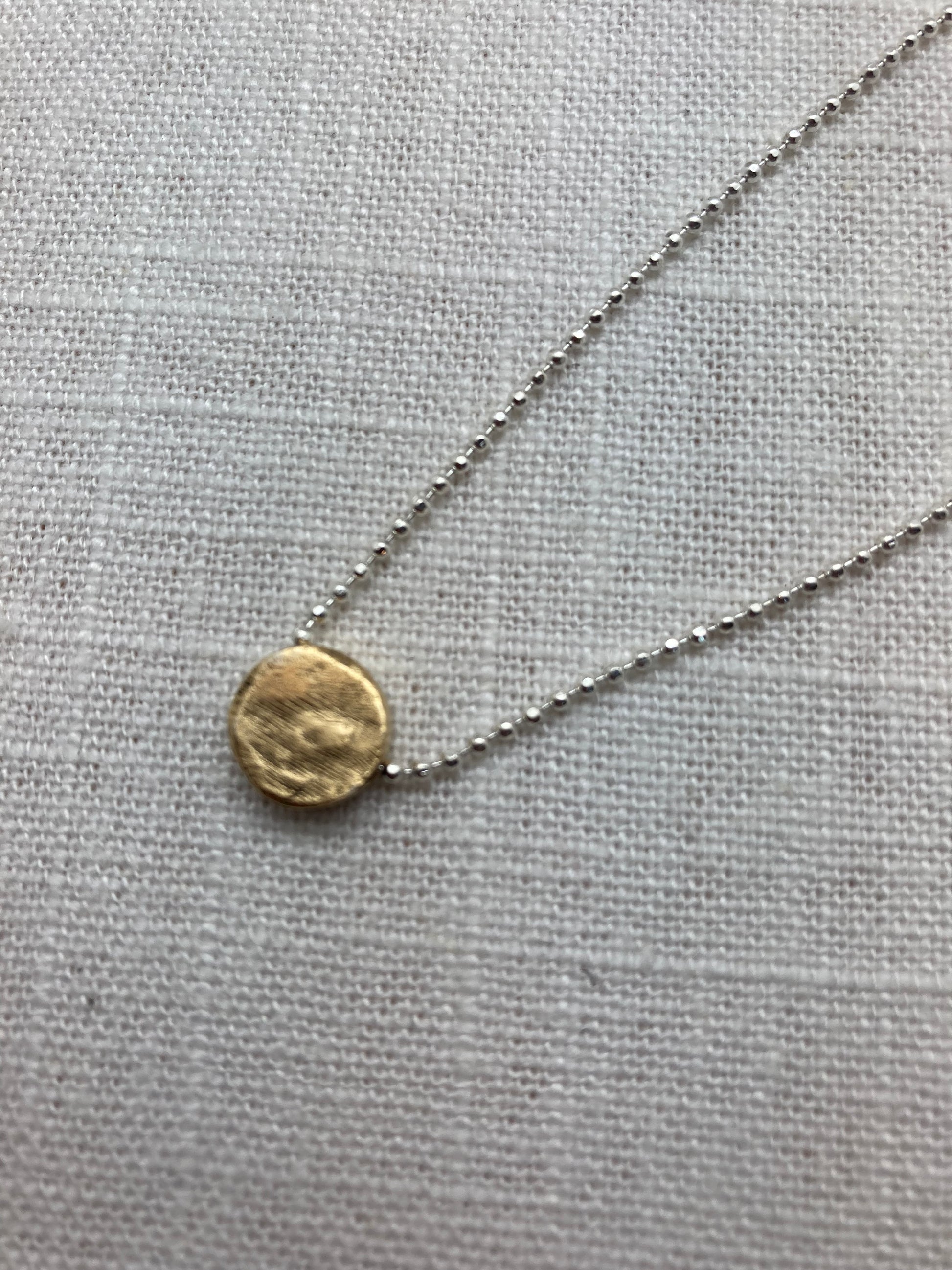 silver bead chain with gold pendant