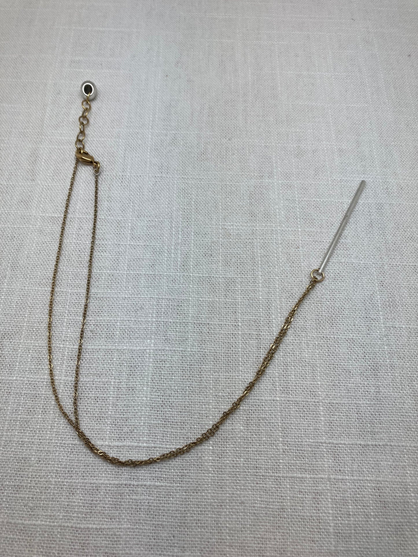 delicate and simple silver plated bar necklace on gold tone chain