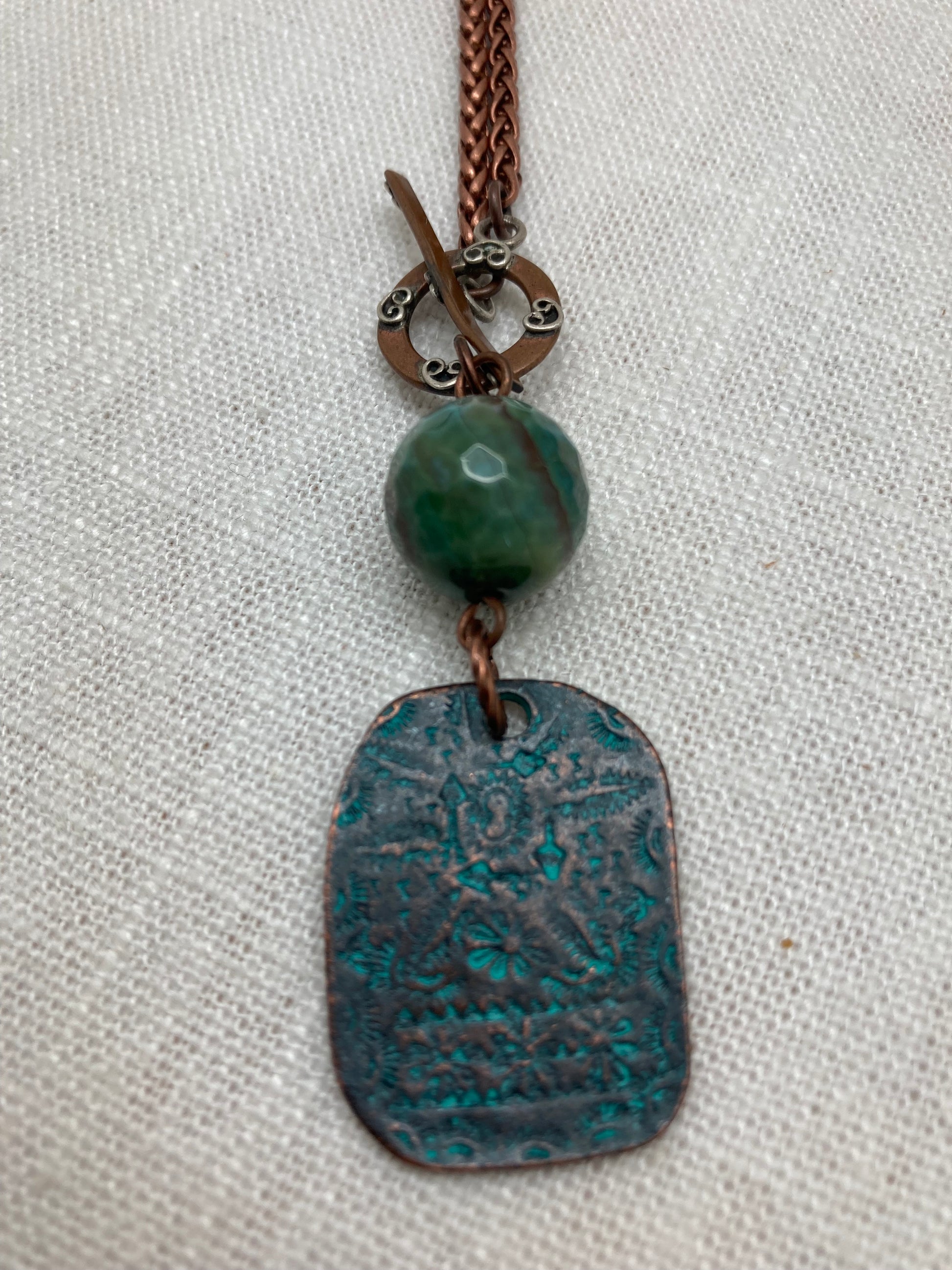 turquoise agate bead and stamped patina copper necklace with flowers