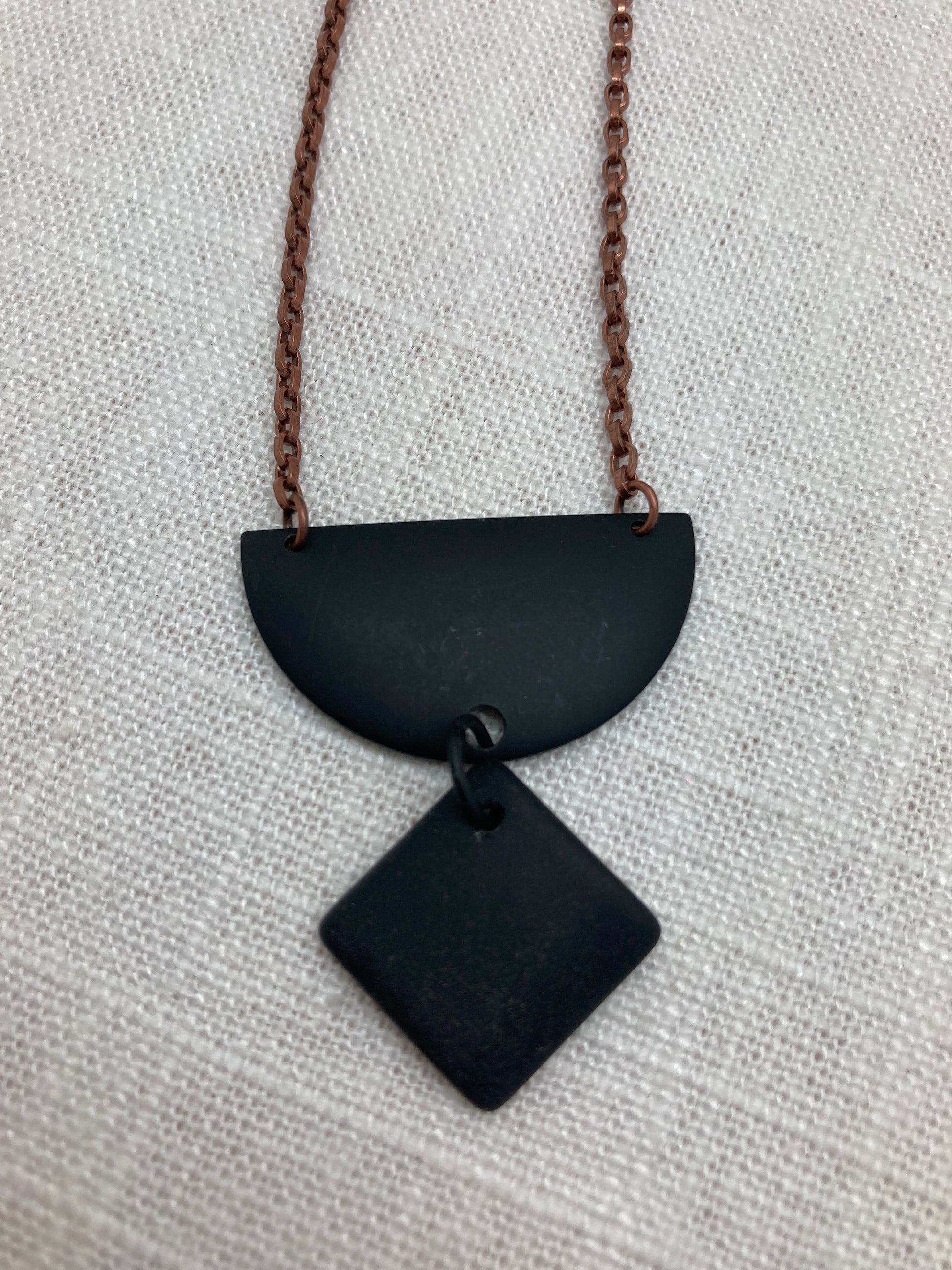 half-moon matte black glass necklace with copper