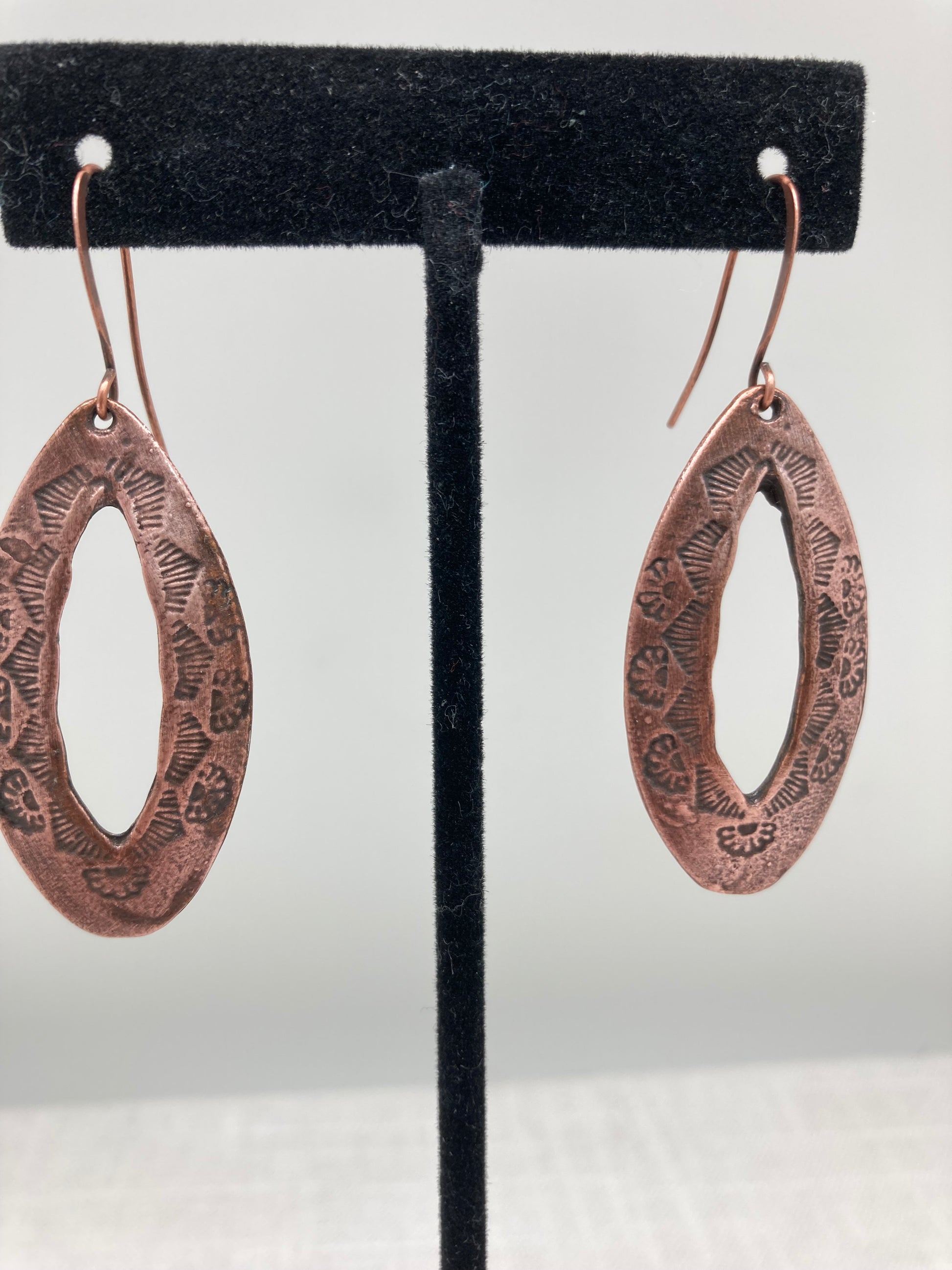 oxidized black and copper earrings with sun pattern