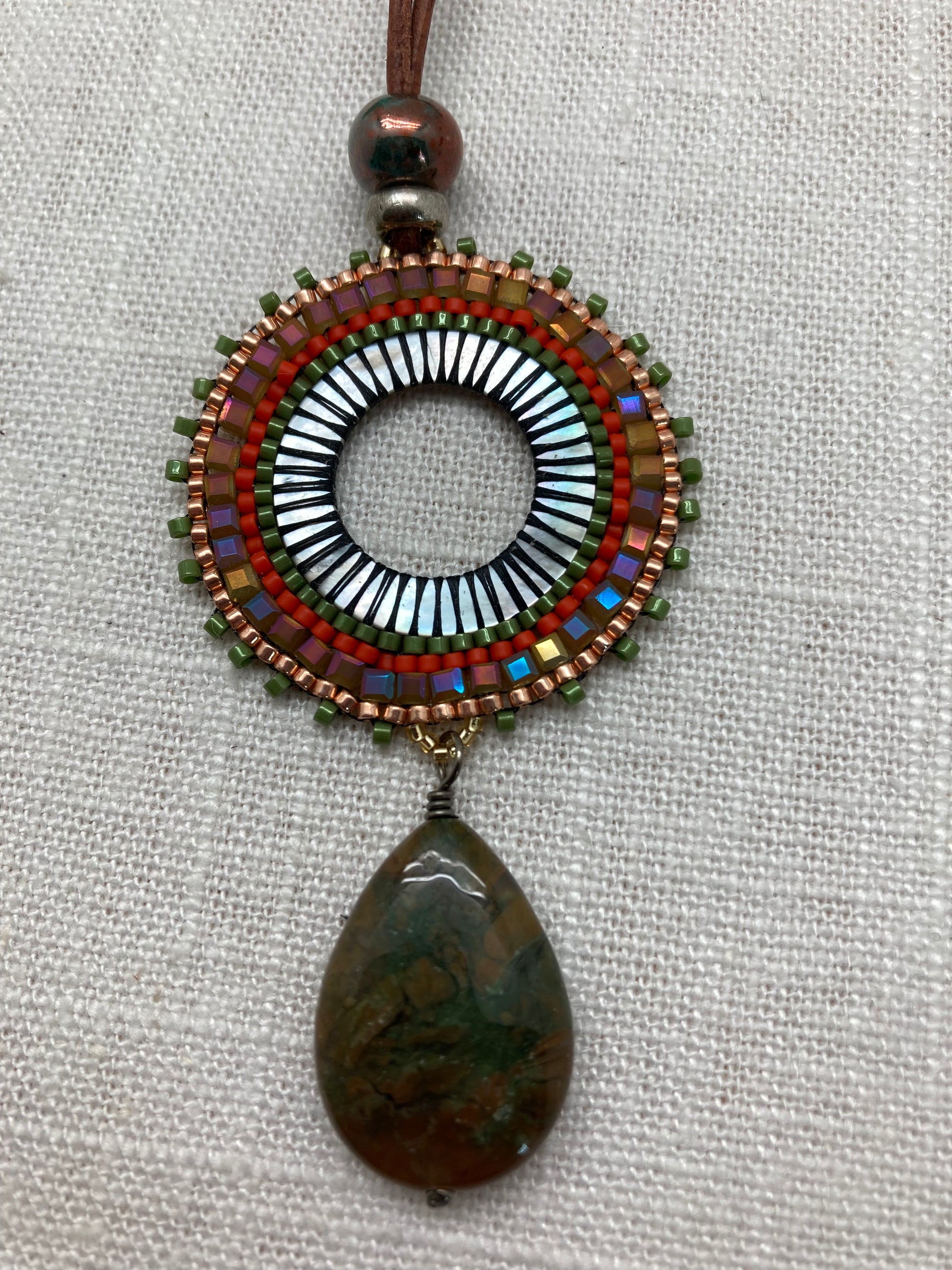 olive and brass long leather necklace with colorful woven design