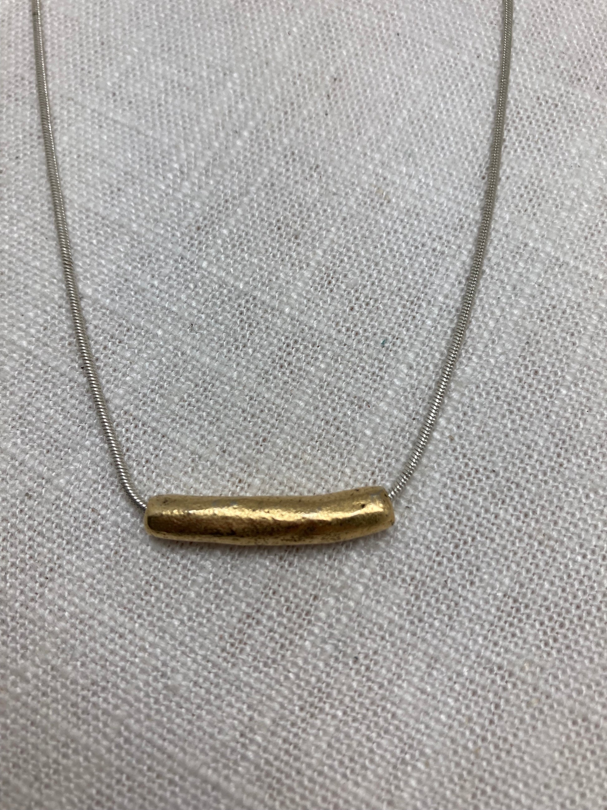 gold tube necklace on silver chain