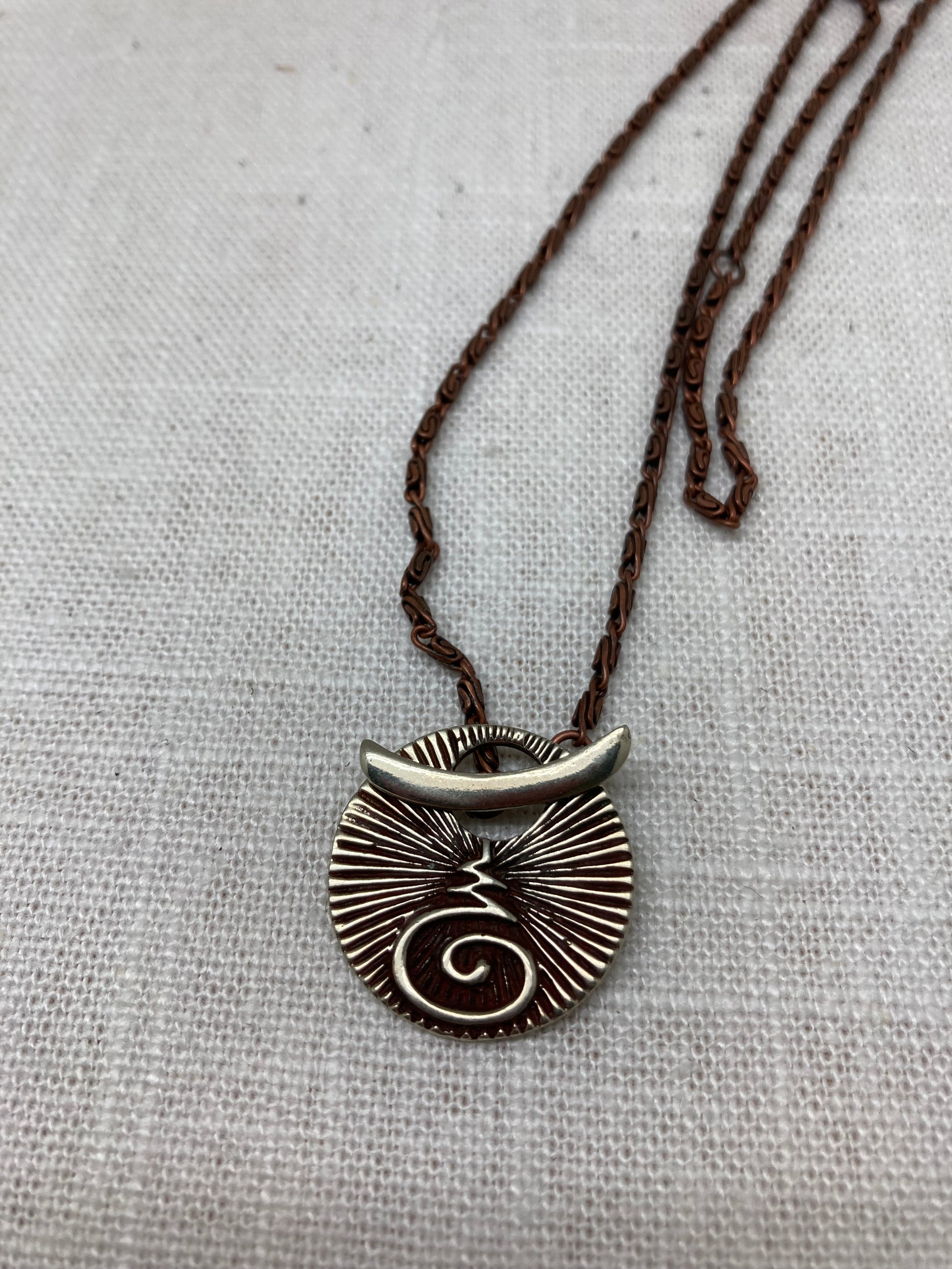 bronze spiral medallion and copper chain necklace