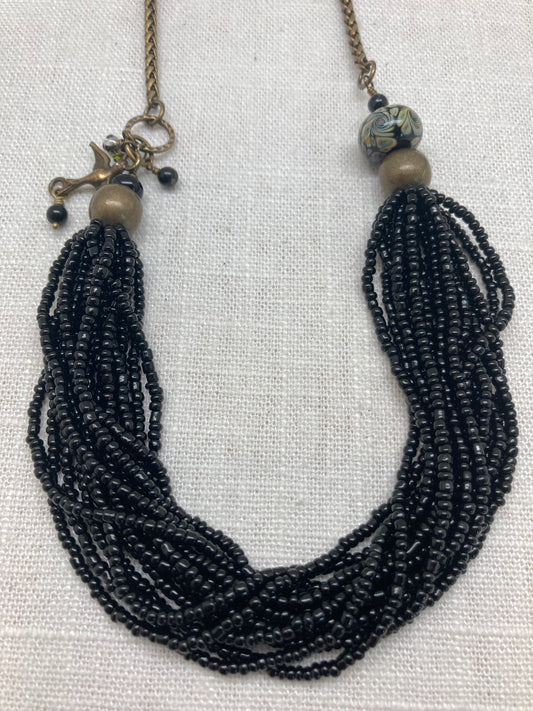 black seed beed necklace on oxidized brass wheat chain with bird charm