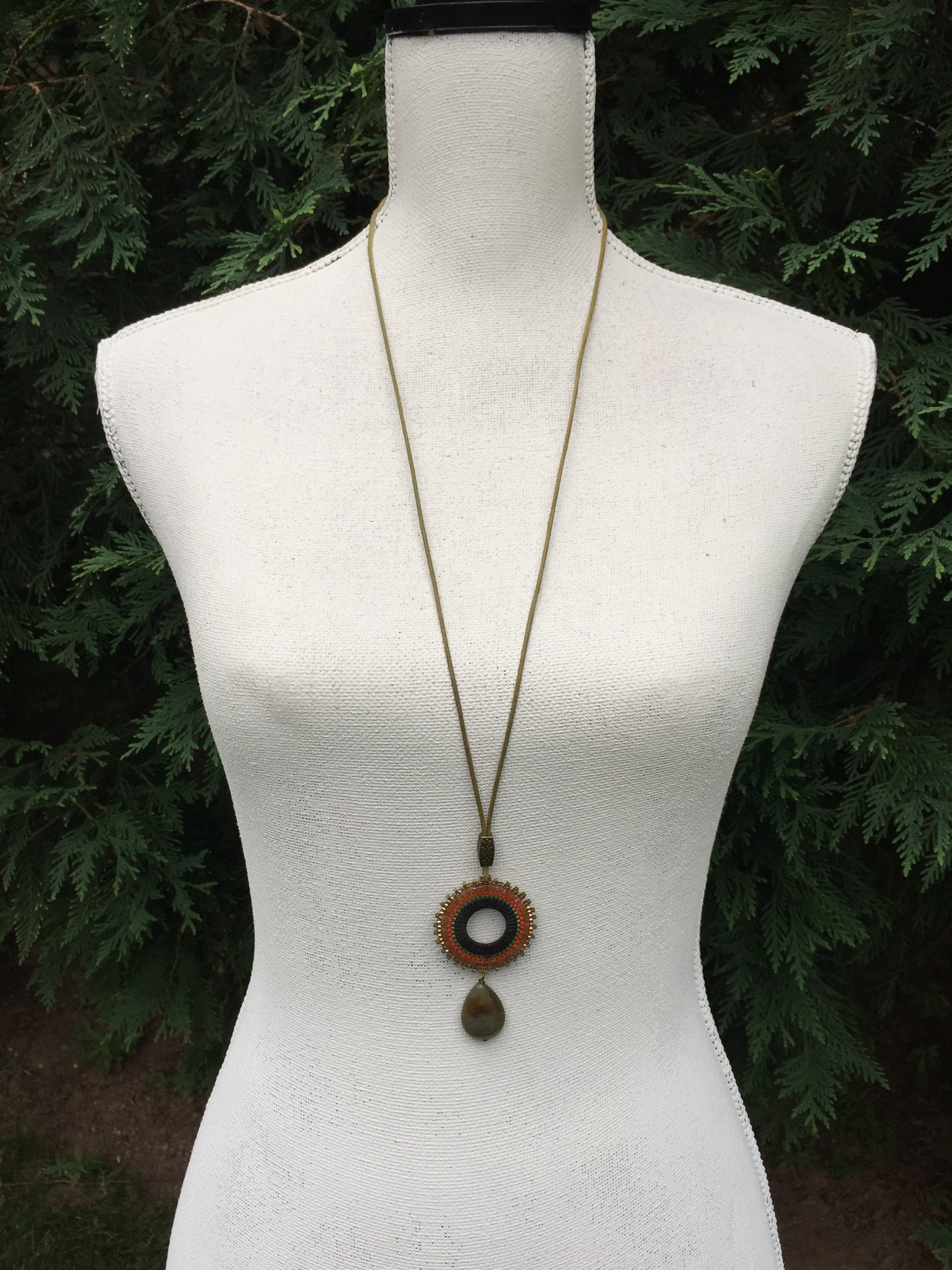 Long light leather necklace with olive and brass pendant
