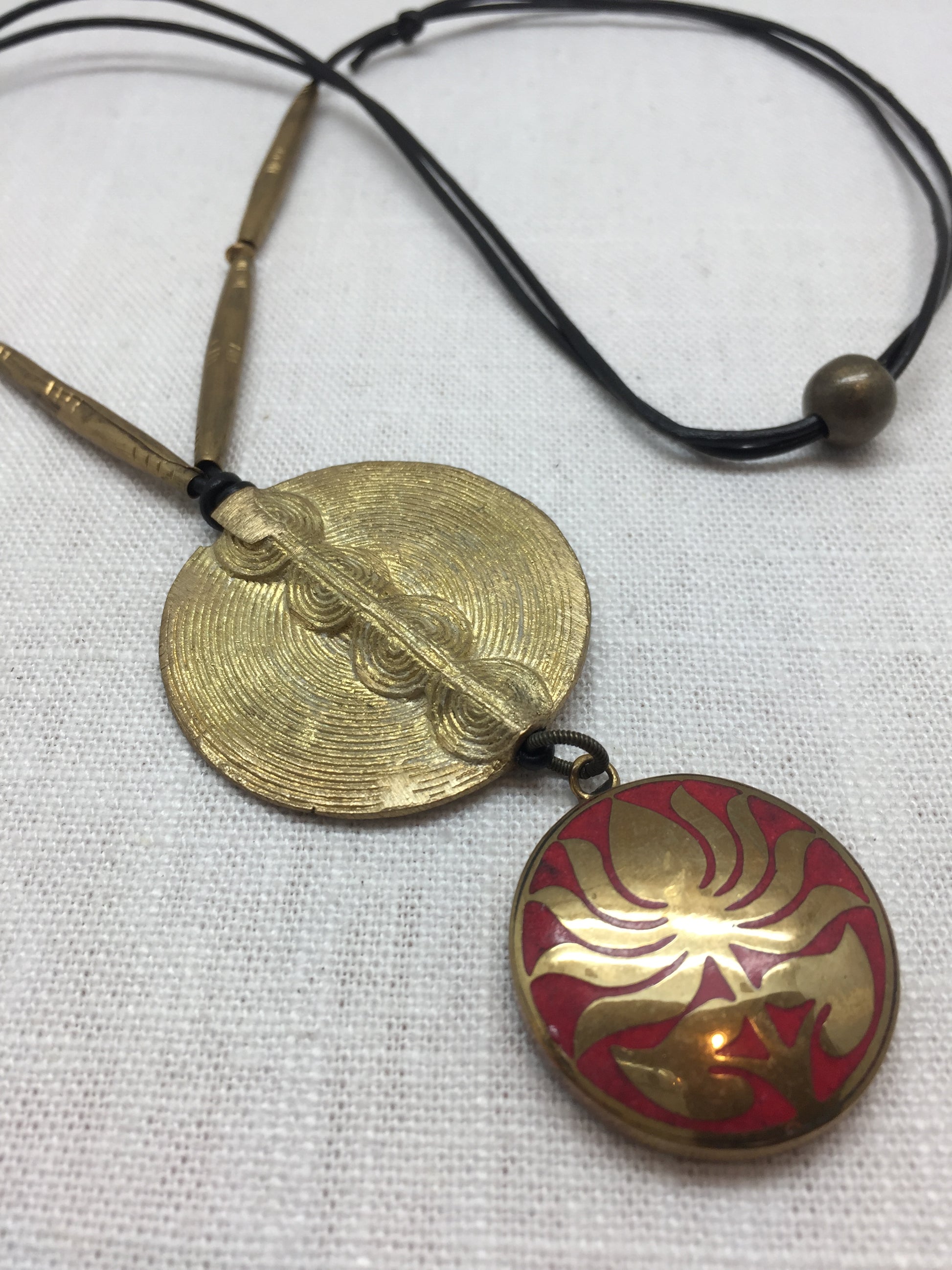 Leather necklace with bronze geometric and red floral medallions from Ghana