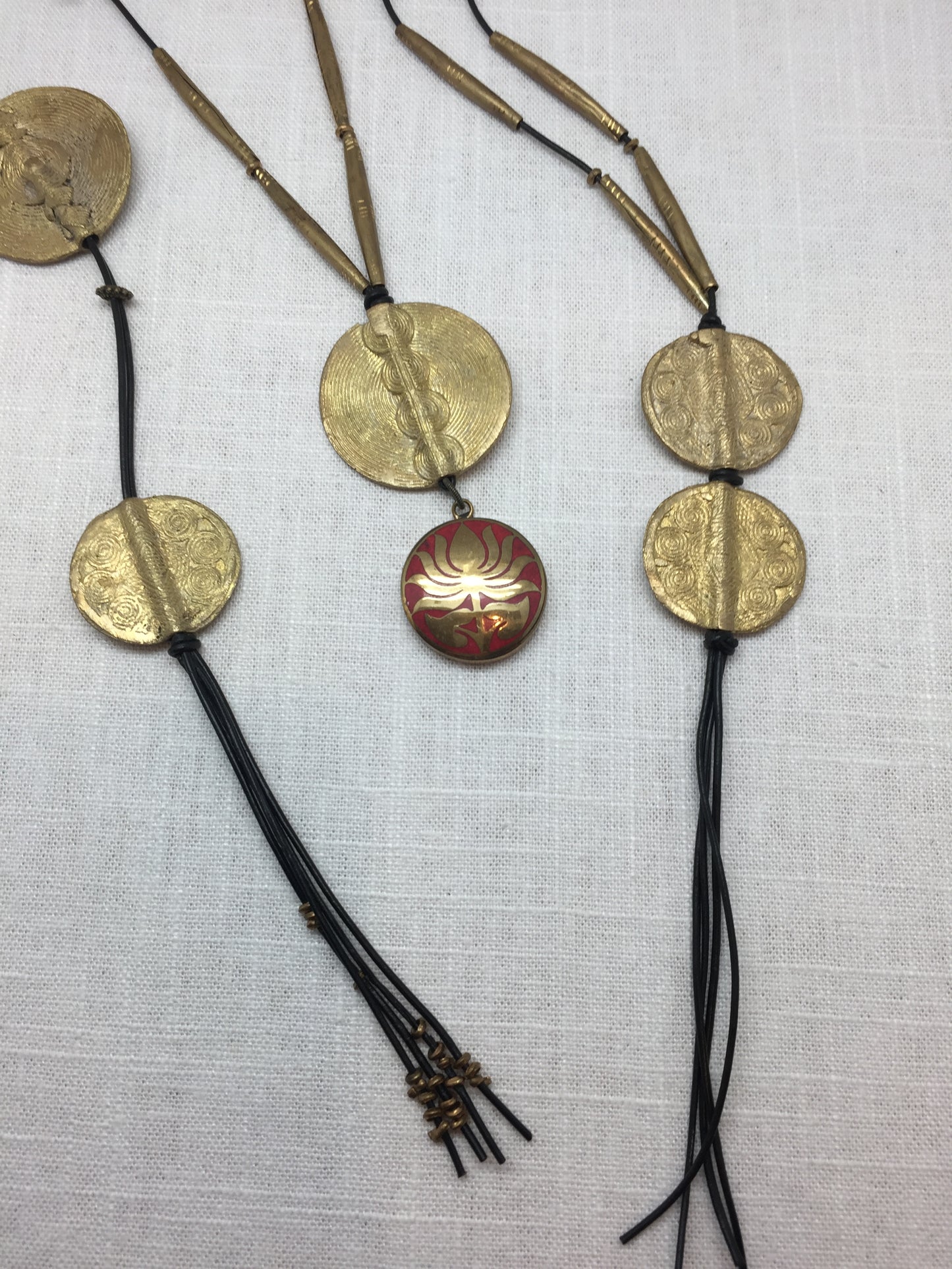 Leather necklaces with brass medallions from Ghana